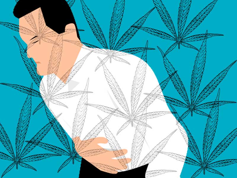 man clutching his stomach to illustrate marijuana help for nausea