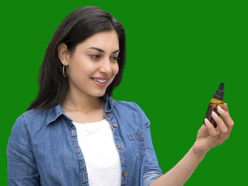 woman looking at cbd bottle to illustrate cannabinoids